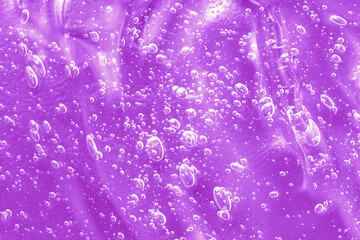 Gel serum liquid jelly texture, cream with collagen and retinol, ceramide, cleanser sample. Cosmetic for skincare. Disinfect smear smudge. Lilac sanitizer swatch with bubbles. Close-up, macro.