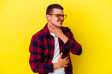 Fototapeta premium Young caucasian cool man isolated on yellow background suffers pain in throat due a virus or infection.