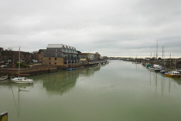 View of the river, boats and buildings in the town