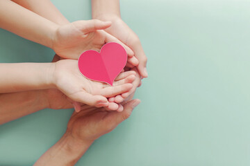 Family hands holding red heart, heart health life insurance, organ donation, volunteer charity, CSR...