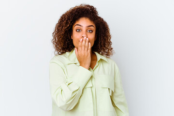 Young african american woman isolated on white background shocked, covering mouth with hands, anxious to discover something new.