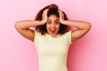 Fototapeta premium Young african american woman isolated on pink background screaming, very excited, passionate, satisfied with something.