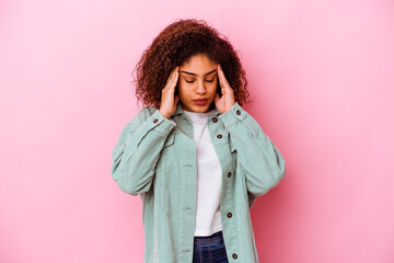 Young african american woman isolated on pink background touching temples and having headache.