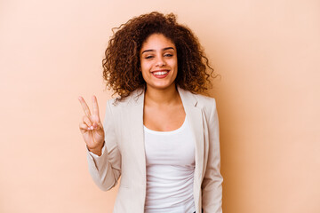 Young african american woman isolated on beige background showing number two with fingers.