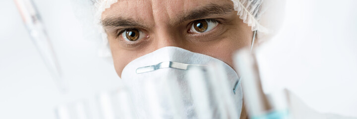 Keen scientist with brown eyes in protective wear loads samples