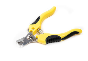 Dog nail trimmer with open blades. Yellow black scissor style clipper with two stainless steel blades. Used by groomers and pet owners to keep dog claws short. Isolated on white. Selective focus.