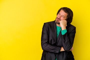 Middle age caucasian man isolated on yellow background who feels sad and pensive, looking at copy space.