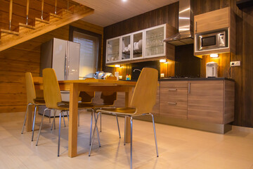 Wooden furniture in a country house. Concept is  production of wooden furniture. Manufacture of furniture for a country house. Cottage interior with dining table. Kitchen interior in a private house