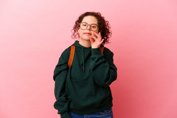 Naklejka premium Young student woman with Down syndrome isolated on pink background biting fingernails, nervous and very anxious.