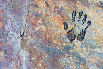 black hand on mountain wall