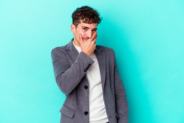 Young caucasian man isolated on blue background scared and afraid.