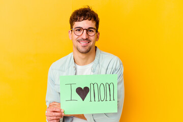 Young caucasian man holding a protect our planet placard isolated laughing and having fun.