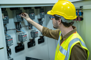 Electrical engineer checking status switchgear electrical energy distribution substation in factory.