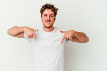 Fototapeta premium Young caucasian man isolated on white background points down with fingers, positive feeling.