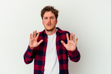 Young caucasian man isolated on white background rejecting someone showing a gesture of disgust.