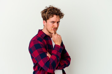 Obraz premium Young caucasian man isolated on white background unhappy looking in camera with sarcastic expression.