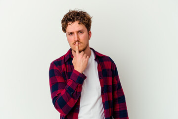 Young caucasian man isolated on white background thinking and looking up, being reflective, contemplating, having a fantasy.