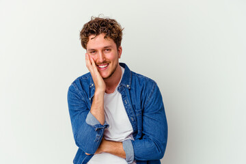 Young caucasian man isolated on white background laughs happily and has fun keeping hands on...