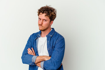 Young caucasian man isolated on white background unhappy looking in camera with sarcastic expression.