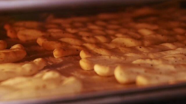 Baked grissini tasty snack made of dough. Grissini baking timalapse in oven