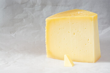 Piece of cheese circle and smoll slice of butter
