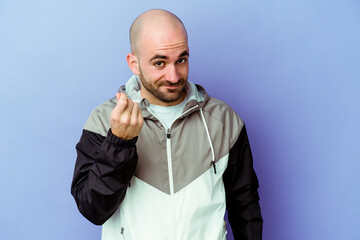 Young caucasian bald man isolated on purple background showing that she has no money.