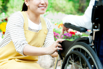 車椅子に乗ったシニア女性と話す女性介護士