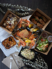 Crab in the bag seafood boil flatlay. Rustic shot of assorted seafood. Crab in creamy butter sauce. 
