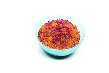 Colored powder in traditional Indian Holi festival celebration bowl,