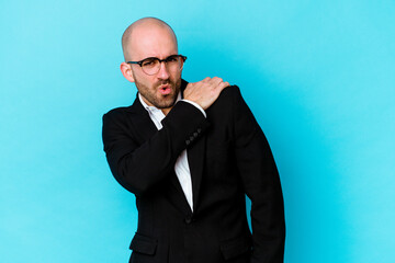 Young business caucasian bald man isolated on blue background having a shoulder pain.