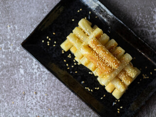 Korean Rice Cakes with Honey (Garaetteok). Dripping honey on tteokbokki (Korean rice cake).
