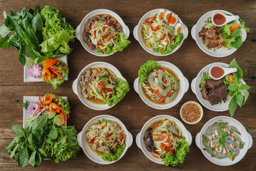 assortment of Thai style spicy papaya salad dish with deep fried meat