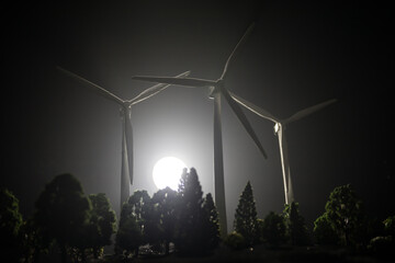 concept idea eco power energy. wind turbine on hill with sunset. Wind Turbine producing alternative...