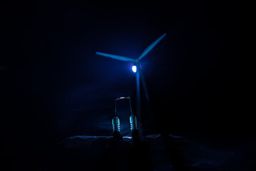 concept idea eco power energy. wind turbine on hill with sunset. Wind Turbine producing alternative energy.