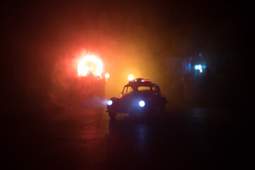 Police car chasing a car at night with fog background. 911 Emergency response police car speeding to scene of crime. Selective focus