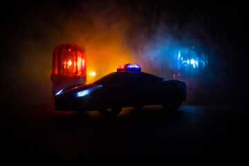 Police car chasing a car at night with fog background. 911 Emergency response police car speeding...