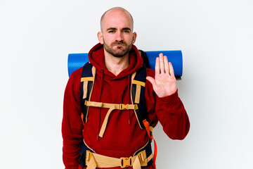 Young caucasian backpacker bald man isolated on white background standing with outstretched hand showing stop sign, preventing you.