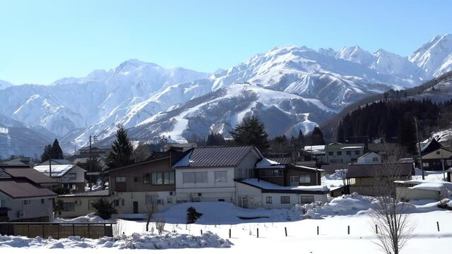 Small town with snowy mountains and winter scenery