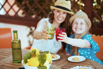 Happy family clinking glasses and having lunch