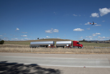 Fototapeta na wymiar A truck and overhead plane on a freeway in an Australian Country Town midway between Sydney and Melbourne 