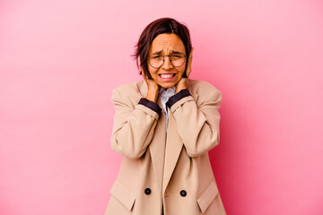 Young business mixed race woman isolated on pink background covering ears with hands trying not to hear too loud sound.