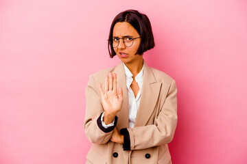 Young business mixed race woman isolated on pink background being shocked due to an imminent danger