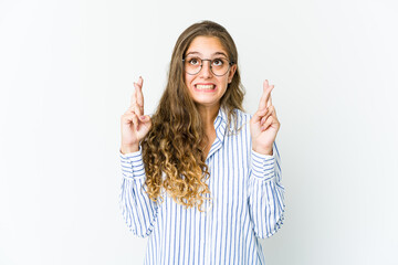 Young caucasian woman crossing fingers for having luck