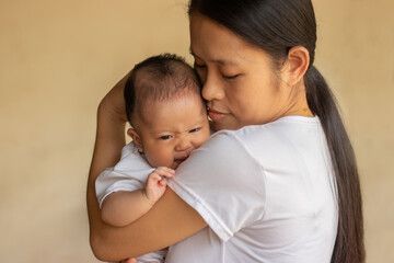 Young Asian mother holding little daughter in the park, Mother play enjoying with her cute baby girl in outdoor, copy space