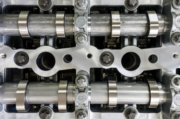 Top view cylinder head of car with intake camshaft and exhaust camshaft device engine on background
