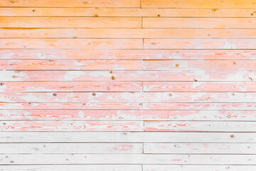 Fototapeta premium Wooden interior texture with orange, white and pink paint, planks background