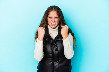 Young caucasian curly hair woman isolated upset screaming with tense hands.