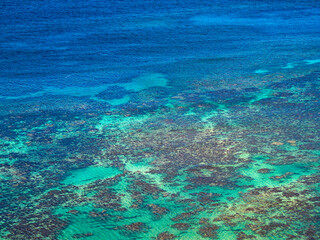 Blue ocean water with coral reef.
