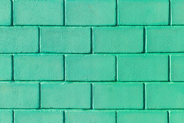 Green or aquamarine wall made of brick blocks color texture azure background