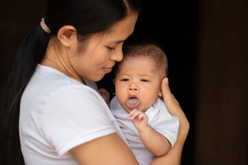 Young Asian mother holding little daughter in the park, Mother play enjoying with her cute baby girl in outdoor, copy space